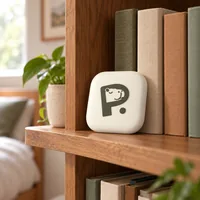Pause Device standing on a bookshelf